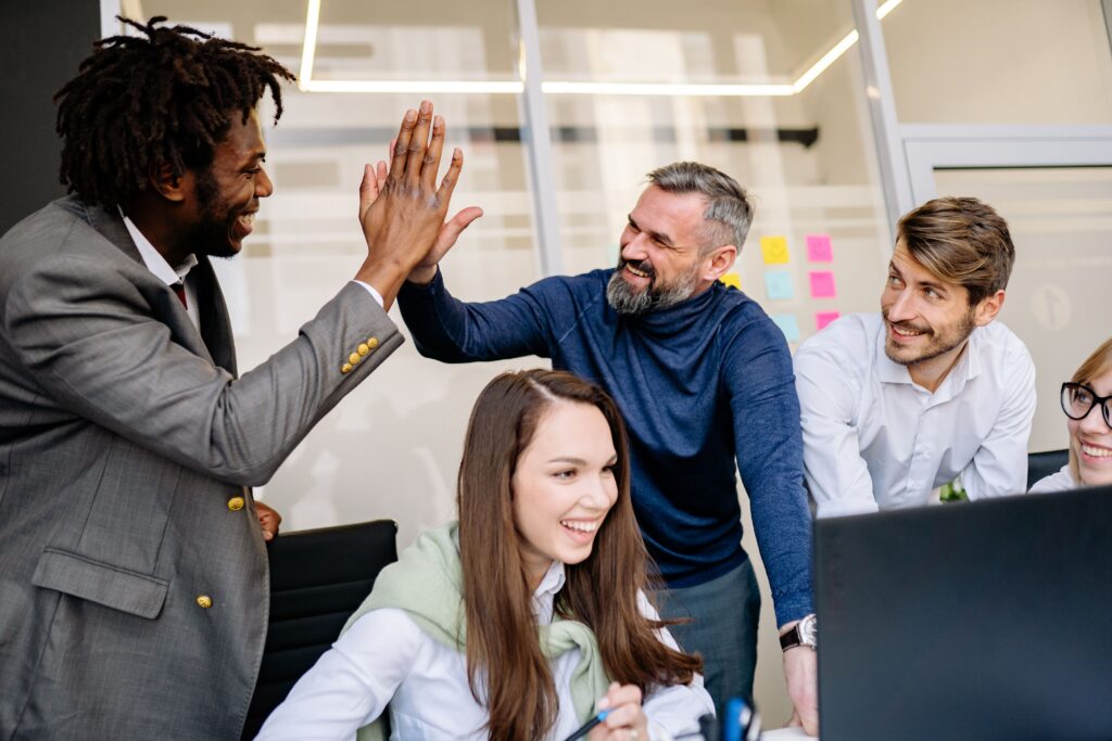 Team of happy office workers with a high five